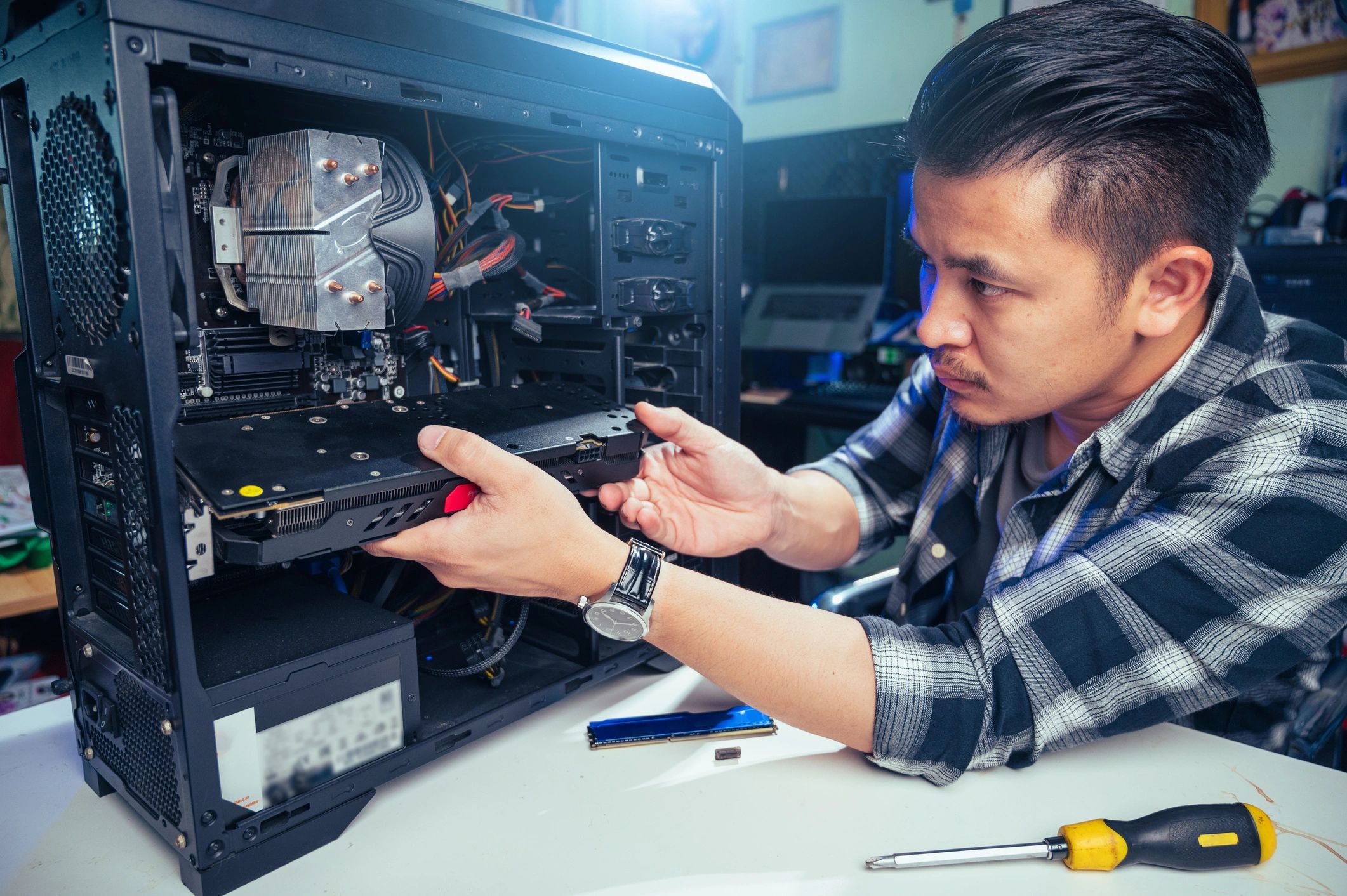 The technician repairing the computer.
